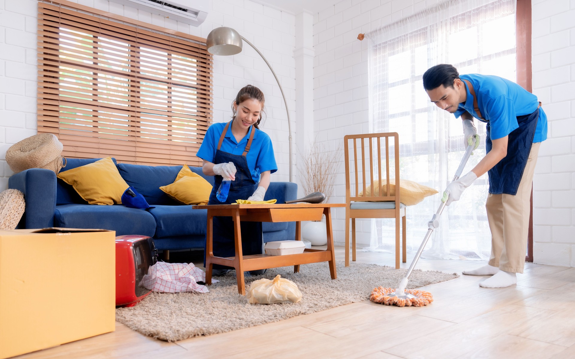 Male and female staff cleaning customers' homes.